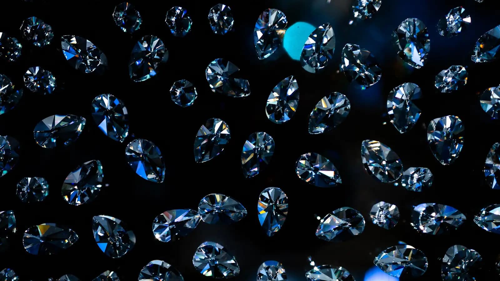 Brilliant cut diamonds scattered across a dark background