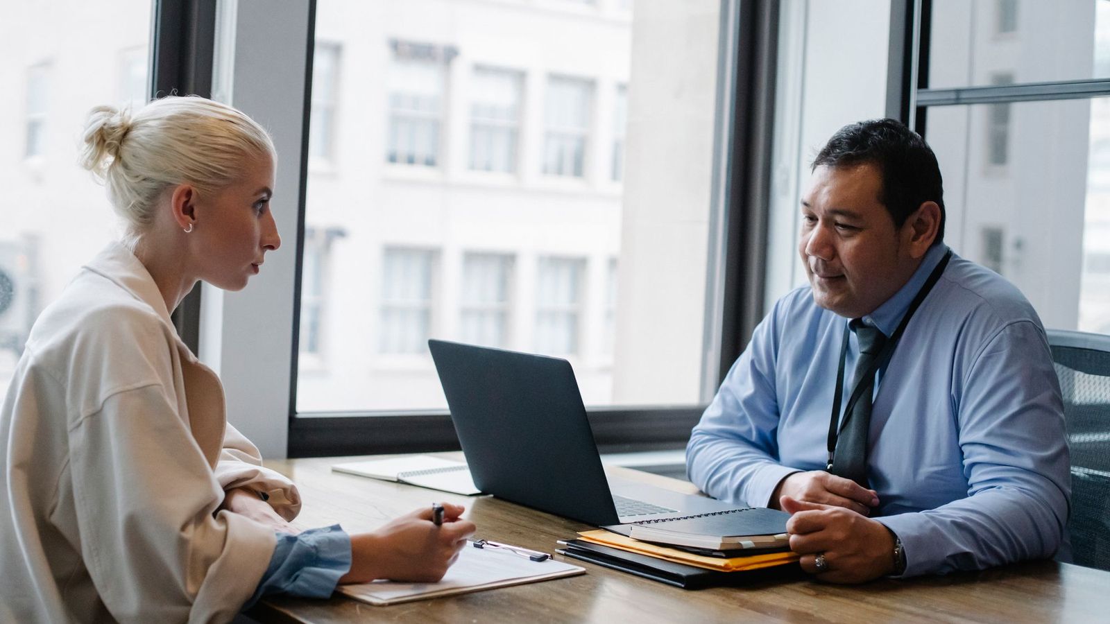 An interviewer and a candidate talking across a desk
