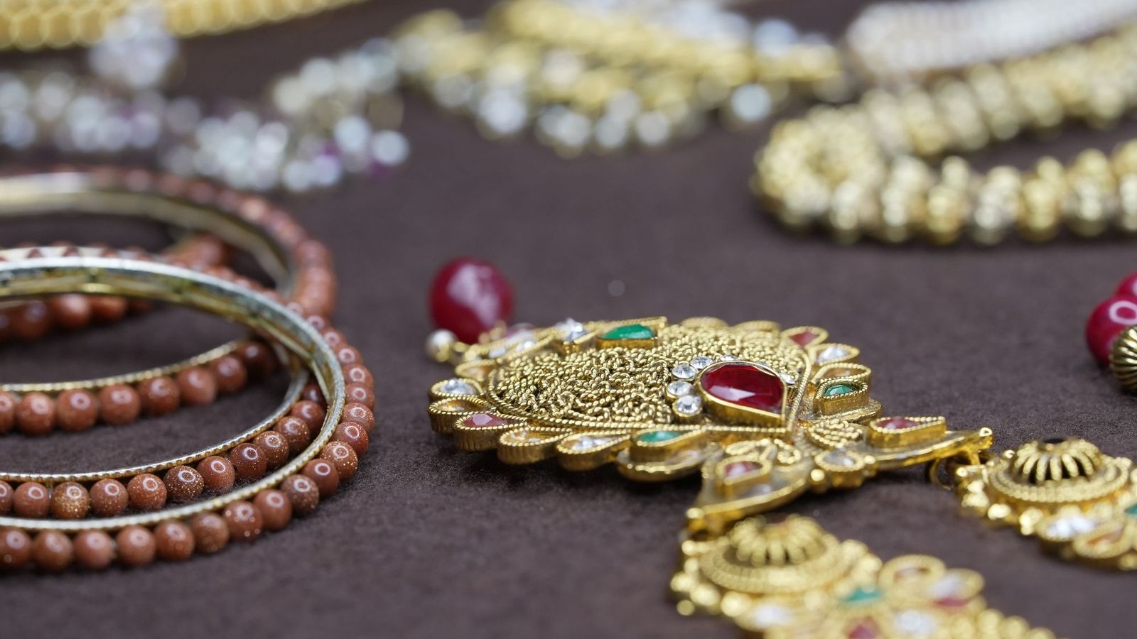 Traditional Indian gold jewellery with rubies and beaded bangles
