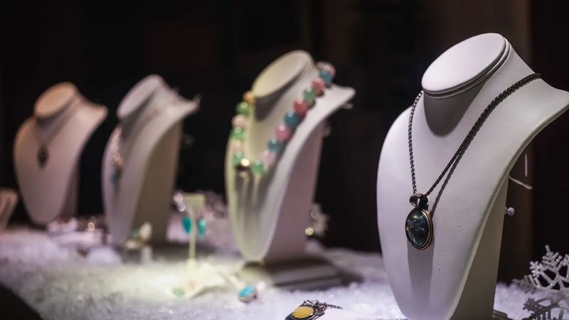 Necklaces displayed on busts in a jewellery store